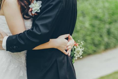 bride and groom dancing with arms wrapped around each other